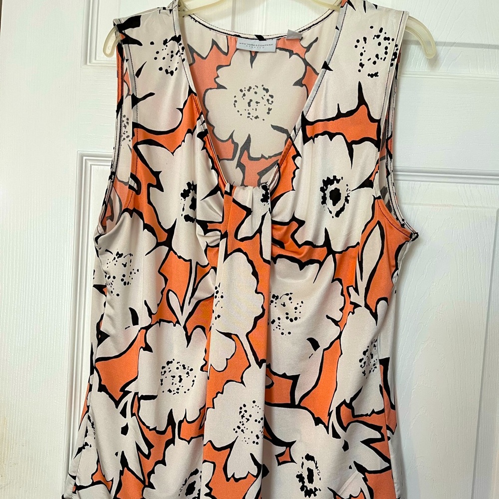 Approx 26in long sleeveless office blouse large white flowers orange background